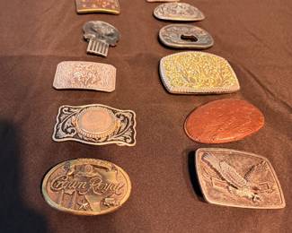 **Vintage Belt Buckle Collection** – Assortment of vintage belt buckles in a variety of styles including Western, hunting, advertising, engraved, and novelty designs. Includes brands such as Crown Royal along with decorative and collectible buckles. Items sold individually unless noted.