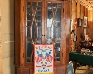 Corner cabinet, WWII welcome home banner