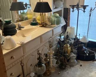 Antique lamps, parts, table and floor.