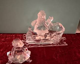 #167 - $70 - Swarovski Santa in a sleigh and a sitting little girl