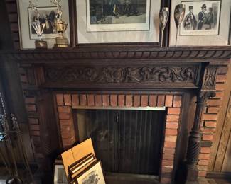 Ornate hand carved dark wood fireplace mantle with intricate scroll work - will require assistance for removal