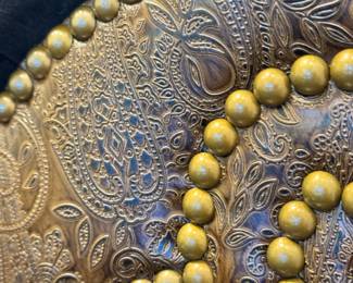 Close up image of the decorative leather with nailhead trim