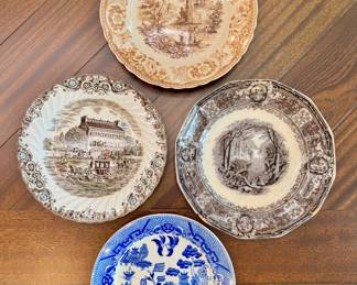 Starting left going clockwise ($8 - Heritage Hall Georgian Town House plate - 9.5”) ($10 - Antique light brown plate with European-style scene - 10”) ($12 - Dark brown Panama plate - 10”) ($10 - Blue and white Japan plate - 9”)
