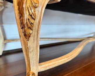 Close-up of the gilded leaf detail on the bench legs