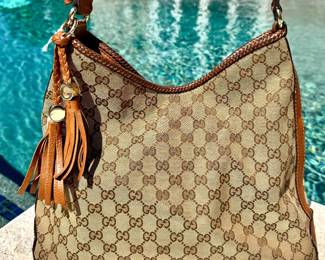 $650 - Gucci hobo bag with leather braded trim, *as is* bottom stitching needs repair, approximately 14' wide x 12" tall