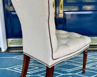 Back view of the beige button-tufted accent chair