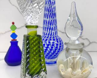 Left to right ($50 - Vintage Murano art glass perfume bottle, 5” tall) ($60 - Vintage green crystal perfume bottle, 6.5” tall) ($30 - Vintage Murano style vase, 8”tall) ($70 - Gibson Glass Co. paperweight bottle ***rare, 6” tall)
