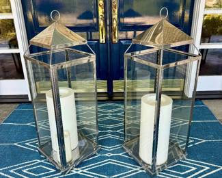 $200 - Pair of extra large chrome lanterns - 13L x 13W x 42H. The latch on one does not properly close. Once in it's display position, wont' be a problem!