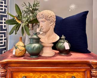 Left to right ($80 - Signed pottery bud vase, 7.5” tall) ($60 - Vintage silver plated glass pitcher, 14” tall) ($200 — Set of two lidded green pottery urns, numbered and signed by artist, 9” tall and 7.5 tall) ($100 - “Head Of An Athlete” Austin Production, *rare, 17” tall) ($100 - Custom velvet pillow with insert, 20” x 20”