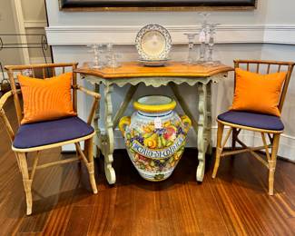 Left to right ($300 - Pair of vintage rattan chairs, armchair 22Lx16Wx32H, side chair 16Lx16Wx32H) ($550 - Demilve table with painted green base, 43L x 22W x 32H) ($800 Artistica large Olio d’ Olivia urn, 23” tall x 19” wide)