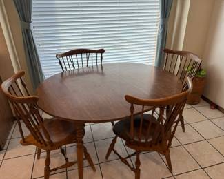 table and chairs shown with leaf