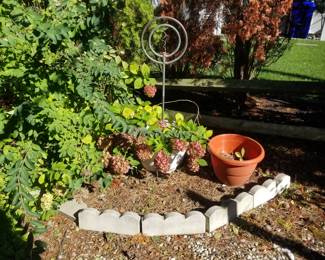 Concrete edging; copper watering sculpture