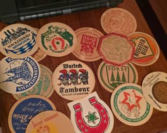 Real vintage beer branded bar coasters. These are being sold as a lot. They will be on this table in the basement until you calmly walk down the stairs, approach the coasters, and respectfully ask their father if you can marry them, and then you give us money and be on your way.