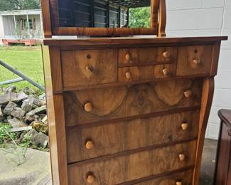 Beautiful antique highboy dresser with matching mirror, striking burled wood grain, multiple drawers, and original style wooden knobs.