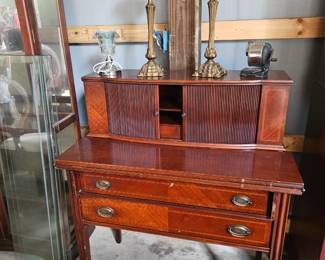 Beautiful antique mahogany writing desk featuring tambour style upper doors, interior storage compartments, and two spacious drawers.