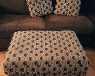 Oversized living room cocktail accent ottoman bundled with two matching geometric throw pillows.