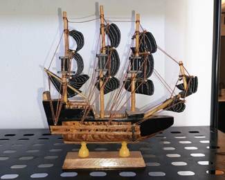 Hand-crafted wooden pirate ship galleon model with black fabric sails and custom rigging cords.