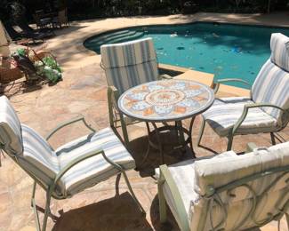 Outdoor chairs with cushions and mosaic table