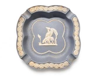 Wedgwood Blue Jasperware Horse Relief Clover Ashtray / Trinket Dish
Condition: Good
Small blue jasperware-style molded dish with four cigarette rests/notched corners, white classical horse-and-foal relief in the center, and repeating cameo border around the rim. Likely used as an ashtray or trinket dish. Visible wear includes light surface scuffing and age toning.