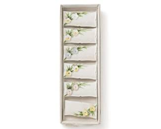 Porcelain floral wall pocket set of 6
Condition: Good
Boxed set of six small white porcelain/ceramic decorative wall-pocket or place-card-holder style pieces, each with raised floral decoration in pastel colors and green leaves. The pieces appear matching and intended as a set.