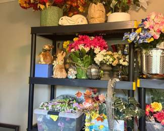 Mixed Artificial Floral Arrangement Lot
Condition: Good
Assorted artificial flowers, faux greenery, and decorative arrangements in multiple containers, including large colorful bouquets on the top shelf and smaller arrangements below. Visible items appear to be mixed and non-matching rather than a unified retail set.