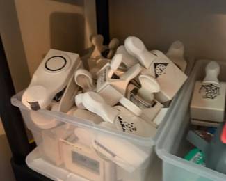 Assorted Wooden Rubber Craft Stamp Lot
Condition: Good
Mixed lot of wood-mounted rubber stamps stored in two clear plastic bins. Visible designs include spiderweb/cobweb motifs, circles, triangles, and other small decorative or office-style impressions. Condition appears used with normal wear expected from craft storage; exact count and completeness are unverified from the photo alone.