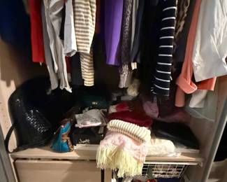 Mixed women’s clothing closet lot with tops, sweaters, pants, scarves, and accessories
Condition: Good
Closet contents including several hanging women’s garments in varied colors/patterns, folded knitwear or scarves, shoes/accessories, and drawer organizers. Primary value is as a mixed resale/clothing lot, not as a single branded item.