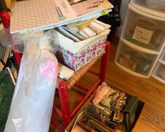 Assorted Scrapbook Paper and Craft Supplies Lot
Condition: Fair
Mixed scrapbooking/paper-craft lot with patterned paper pads or sheets, loose paper packs, and assorted small crafting supplies. The photo suggests a bulk destash from a scrapbooker or crafter rather than a single retail set. Secondary items in the scene include storage bins and a rolled paper or poster tube, but the salable focus is the craft lot.