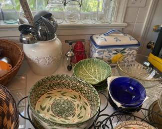 Hand-Painted Ceramic Floral Nesting Bowl Set
Condition: Good
Foreground grouping of decorative ceramic nesting bowls in green, blue, and cream tones with floral/botanical patterns; likely intended as serving or mixing bowls. Secondary kitchen items and other glassware in the background are not counted as part of the primary item.