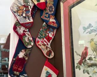 Handmade Needlepoint Christmas Stocking Set with Assorted Santa, Reindeer, and Holiday Scenes
Condition: Good
Decorative group of seven Christmas stockings with needlepoint/embroidered fronts in varied holiday motifs. Visible designs include Santa figures, a reindeer scene, an angel, and other festive imagery. Different colors and patterns suggest these were collected or hung individually rather than sold as a single matching set.