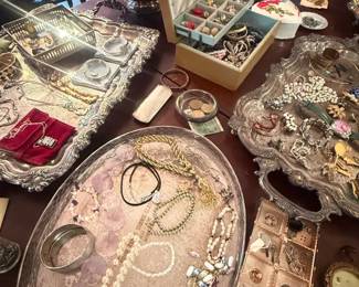 Assorted Vintage Costume Jewelry Mixed Lot
Condition: Good
Large mixed estate lot of costume jewelry displayed across several trays and boxes, including tangled necklaces, bracelets, earrings, rings, brooches/pins, and small decorative items. Visible finishes include silver tone, gold tone, rhinestone, pearl-like beads, and assorted colored stones. Exact piece count is not determinable from the image alone.