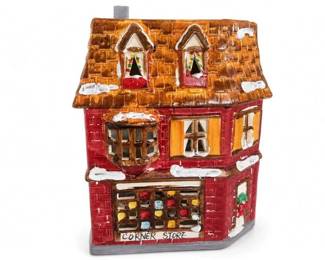 Department 56 Snow Village Corner Store lighted ceramic building
Condition: Good
Small decorative miniature village building shaped like a corner store, hand-painted in red, brown, orange, and white with faux snow on the roof and ledges. Appears to be a holiday/Christmas village piece, possibly lighted, but the interior wiring or plug is not visible clearly enough to confirm from the image alone.