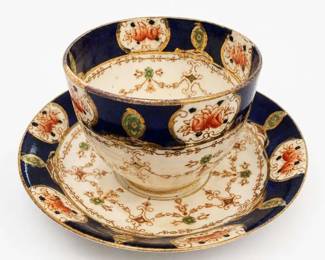 Cobalt Blue Floral Gilt Porcelain Tea Cup and Saucer
Condition: Good
Single porcelain teacup with matching saucer, cobalt blue border, white ground, floral reserves, and gold gilt decoration. Decorative tea service style, likely vintage or antique. No chips, cracks, or repairs can be confirmed from the image alone.