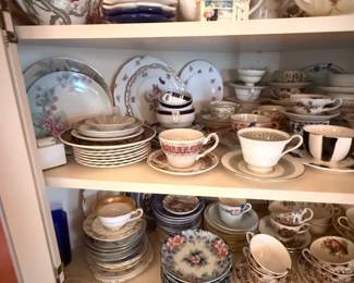 Mixed Floral Bone China Tea Cup and Saucer Collection
Condition: Good
Assorted floral tea wares in bone china/porcelain style, including multiple teacups, saucers, and plates with various flower patterns. The lot appears mixed and incomplete, with several different patterns and sizes visible; secondary decorative pieces in the cabinet are not included in the identification.