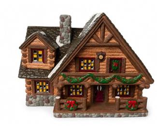 Ceramic Christmas Village Lighted Cottage Holiday House
Condition: Good
One decorative Christmas village house/cottage in a rustic chalet style, brown/tan with faux-stone base and chimney, snow accents, wreaths, garland, and multi-pane window detailing. Appears to be a ceramic or resin holiday display piece.