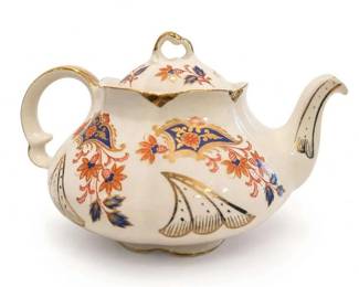 Porcelain Floral Gilt Teapot
Condition: Good
Cream porcelain teapot with rounded body, loop handle, high spout, lid finial, and elaborate orange, blue, and gold floral/paisley-style decoration. Gilt trim is visible on the lid, rim, handle edge, and foot. Decorative condition appears generally good from the photo, with no obvious large chips or cracks visible.