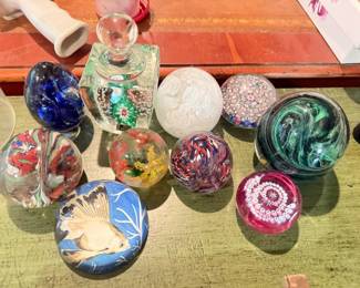 Mixed Art Glass Paperweight Lot, 10 Pieces
Condition: Good
Assorted decorative glass paperweights in multiple colors and patterns: swirl designs, millefiori/floral canes, a clear faceted/captive-bubble style piece, a white textured sphere, a pink floral sphere, and a painted fish paperweight. Mixed size and design lot; intended as separate display pieces rather than a coordinated set.