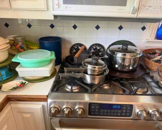 Tupperware pastel green nesting food storage container set
Condition: Good
Primary salable item is the pastel green/white plastic food storage grouping at left-center of the image. The rest of the frame contains additional kitchenware, including covered cookware, utensils, and baskets, which should be treated as background unless sold as one lot.