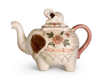Hand-painted floral elephant-shaped ceramic teapot
Condition: Good
Cream-colored ceramic elephant-shaped teapot with applied floral motifs, pink loop handle, curved trunk spout, and elephant finial lid. Decorative rather than utilitarian; likely a vintage novelty tea server. Origin, maker, and age remain unverified from the image.