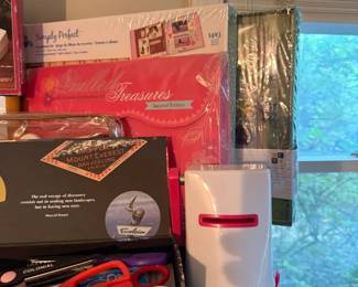 Assorted scrapbooking supply lot with sealed kits and tools
Condition: Good
Mixed lot of scrapbooking/craft supplies including at least one sealed scrapbook kit/package, scissors, and other small craft items. Condition appears generally good for storage items, with some packaging reflection/wear and several items only partially visible. Secondary objects in the frame should be treated as included lot contents, not separate listings, unless individually verified.