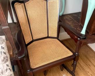 Vintage cane seat and back armchair
Condition: Good
Dark wood armchair with curved arms, turned front legs, and woven cane panels on the back and seat. The back has a three-panel, fan-like shape. Visible wear is present; the cane appears intact from this angle, but close inspection of the underside and joints is needed to confirm condition and any repairs.