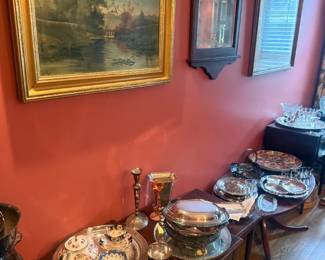 Ornate Mixed Silverplate Servingware and Tableware Lot
Condition: Good
Assorted decorative silverplate-style serving pieces and tableware, including stacked plates, covered serving dishes, trays, and candlesticks in a formal dining-room display. Condition appears mixed from the photo; surface wear, tarnish, and completeness are unverified at this distance.