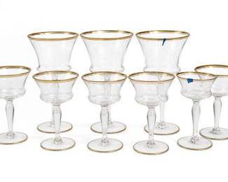 Clear Glass Gold-Rim Sherbet Coupe Stemware Set of 8
Condition: Good
Set of 8 clear glass stemmed coupe/sherbet glasses with gold rims and wide shallow bowls. Mixed presentation of taller and shorter stems, but overall appears to be a matching service set. No obvious chips are visible in the photo, though condition of rims and bases should be checked in hand.