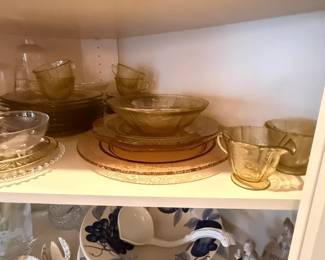 Amber glass serving bowl lot
Condition: Good
Assorted amber-tinted glass serving pieces, including stacked bowls and matching-looking plates/saucers in various sizes. No visible chips or cracks can be confirmed from the photo, but condition is only partially visible.