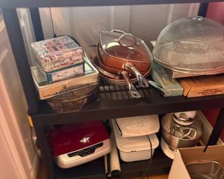 Copper cookware mixed lot of pots and pans with lids
Condition: Good
Assorted copper cookware displayed on a black shelf, including at least one lidded copper pan in the center and a domed-lid piece on the right. Condition appears used with normal shelf wear; exact completeness and maker are unverified.
