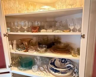 Assorted vintage clear glass and crystal servingware lot
Condition: Good
Assorted clear stemware, goblets, bowls, platters/plates, and serving pieces displayed together in a lit cabinet. Visible pieces include multiple rows of glassware, a few colored pieces, and several decorative serving dishes; quantity appears substantial but exact count is not reliable from this single photo.