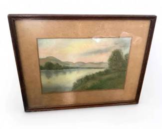 Framed landscape pastel or print of river, mountains, and trees
Condition: Good
Single framed landscape image under glass or glazing, showing a calm body of water, distant hills, and trees. The surface looks more like a pastel, charcoal, or printed art piece than a thick oil painting, but the medium cannot be confirmed from the photo alone. Frame shows age/wear appropriate to a vintage decorative piece.