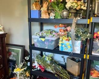 Mixed Artificial Silk Flower Assortment / Floral Decor Lot
Condition: Good
Large mixed grouping of artificial flowers and floral stems in assorted colors, likely intended for home decor, arrangements, or craft use. Visible pieces include bouquets, loose stems, and floral filler; some appear stored in bins and baskets on shelving. No single branded product or exact matching set is evident.