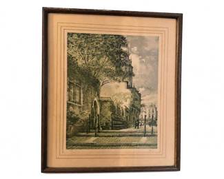 Framed vintage city street scene lithograph print
Condition: Good
Decorative framed print or lithograph depicting a narrow urban street with buildings, trees, and a few figures. Appears to be a single matted piece in a dark wood frame. No visible damage can be confirmed from the photo beyond normal age toning of the mat and frame wear.