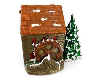 Ceramic Christmas Village Watermill House with Tree
Condition: Good
Small ceramic Christmas village building shaped like a watermill or riverside cottage, painted in earthy tones with white snow highlights and a textured roof; includes a separate green evergreen tree accessory.